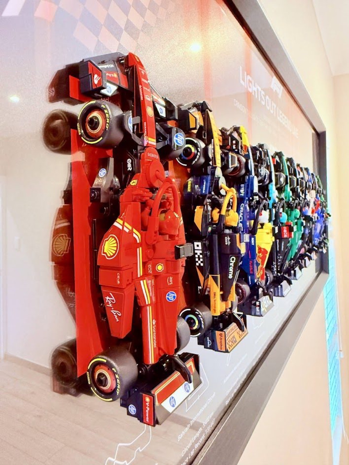 Speed Champions cars clipped into a grid frame, seen from the left