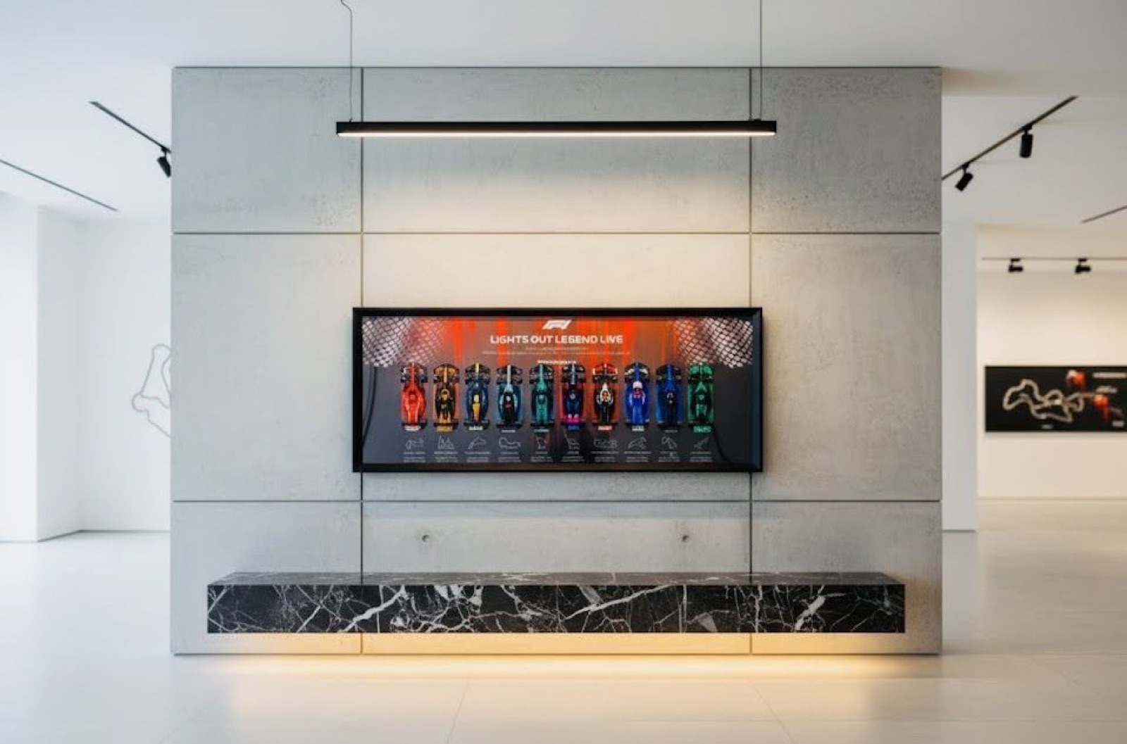 A grid frame above a marble console in a gallery space